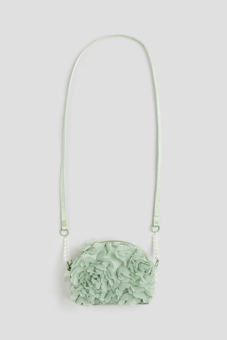 Fabric flower-covered shoulder bag